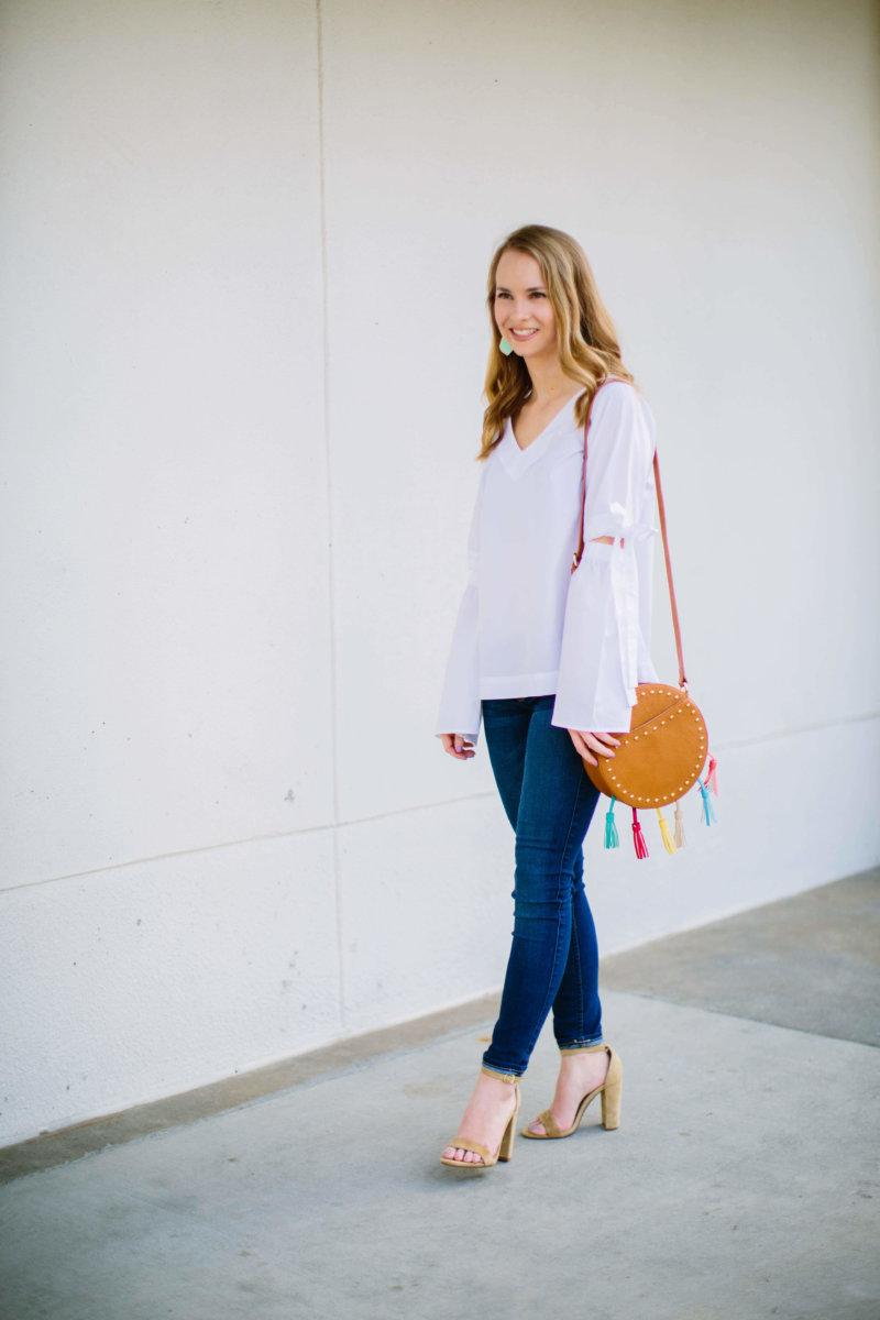 This white bell sleeve vee top is going to be on major repeat well into the summer. The material is super light and breathable, making it the perfect go-to top. I am absolutely in love with the fit, and how darling are the bow details on the sleeves!